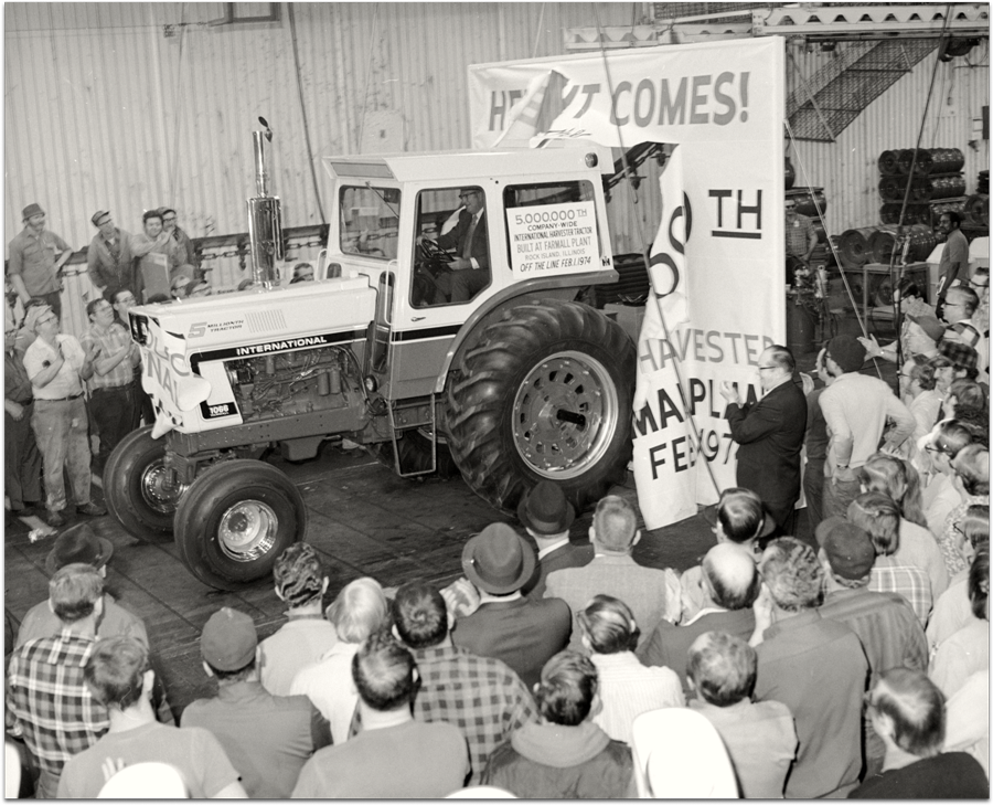 Black and white image of group gathered to celebrate the 5 millionth Farmall to roll of the production line