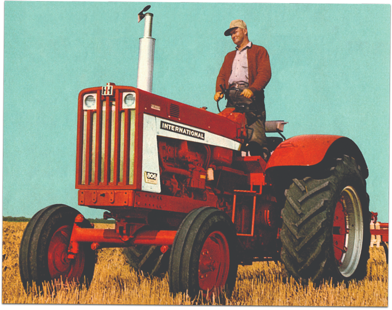 Man standing on a 1954 tractor in field