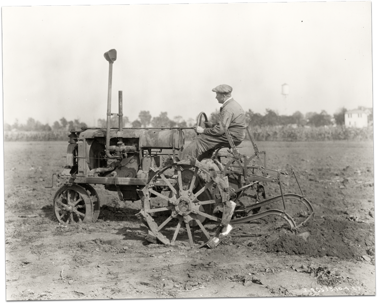 Black and white image of a Farmall tractor in a field circa 1923