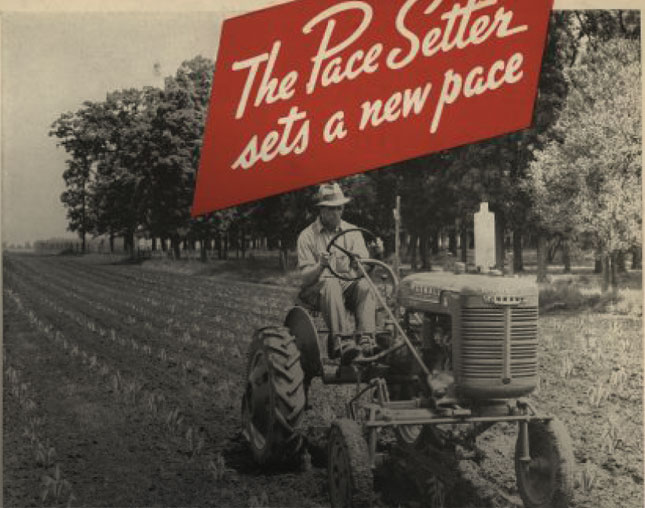 Historic Farmall tractor ad "The Pace Setter sets a new pace" billboard with man riding Farmall